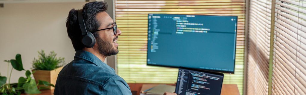 Male freelancer making new project as web designer or programmer on his computer at home office