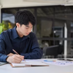 focused young asian male financial analyst accountant working financial report 67155 29322