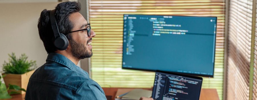 Male freelancer making new project as web designer or programmer on his computer at home office